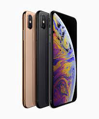 Three Apple iPhone XS Max 256GB models are shown, facing left, in gold and black, with the front device displaying a colorful abstract image. Available at Saisales.co.uk.